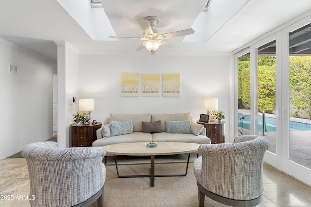 living area with ceiling fan, visible vents, and ornamental molding