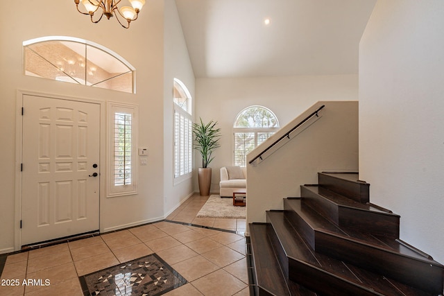 1125 S Larkspur St, Gilbert, AZ 85296 - foyer featuring light tile patterned flooring, a chandelier, stairs, high vaulted ceiling, and baseboards