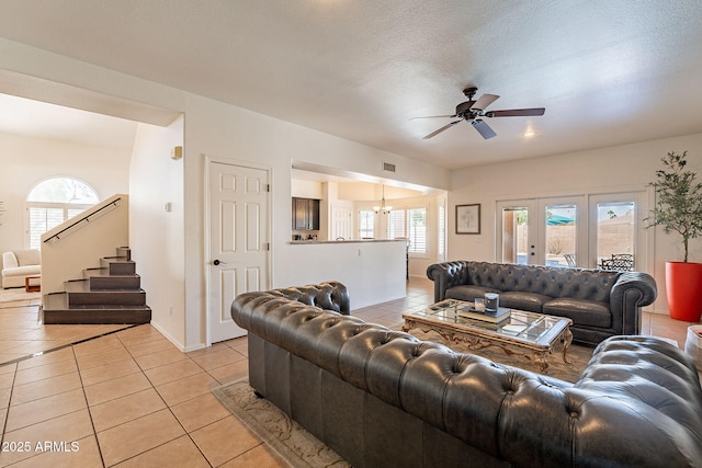 1125 S Larkspur St, Gilbert, AZ 85296 - living area with light tile patterned floors, a ceiling fan, a chandelier, and stairway