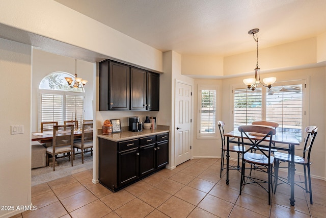 1125 S Larkspur St, Gilbert, AZ 85296 - kitchen with a chandelier, light tile patterned floors, light countertops, and hanging light fixtures