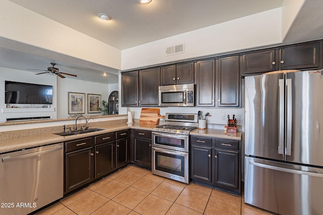 1125 S Larkspur St, Gilbert, AZ 85296 - kitchen featuring stainless steel appliances, a sink, light tile patterned floors, ceiling fan, and open floor plan