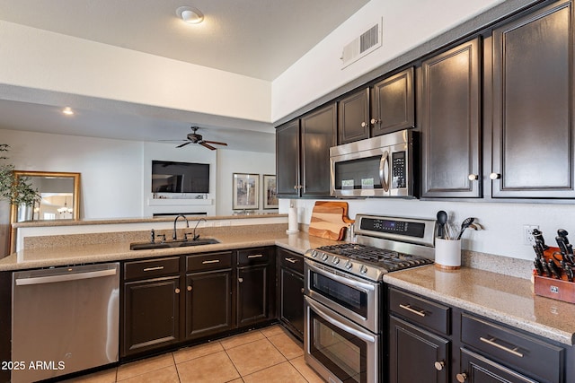 1125 S Larkspur St, Gilbert, AZ 85296 - kitchen with appliances with stainless steel finishes, a sink, light tile patterned floors, a peninsula, and ceiling fan