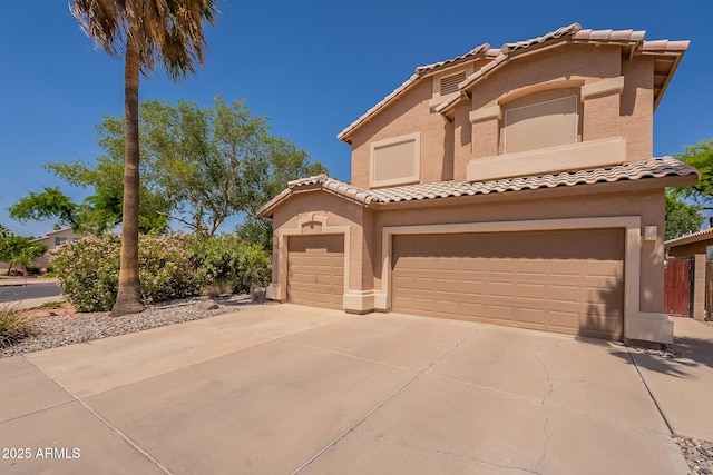 1125 S Larkspur St, Gilbert, AZ 85296 - mediterranean / spanish-style home featuring stucco siding, concrete driveway, a tile roof, and an attached garage