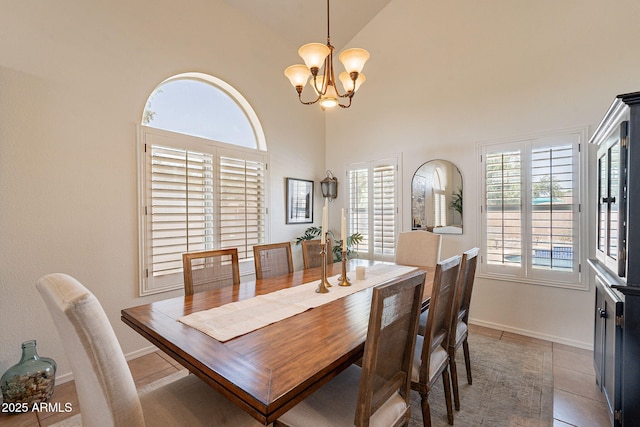 1125 S Larkspur St, Gilbert, AZ 85296 - dining area with a chandelier, light tile patterned flooring, high vaulted ceiling, and baseboards