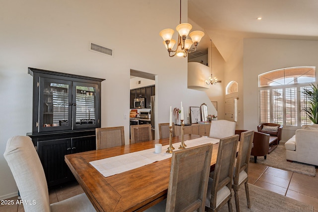 1125 S Larkspur St, Gilbert, AZ 85296 - dining area featuring a chandelier, a towering ceiling, and light tile patterned floors