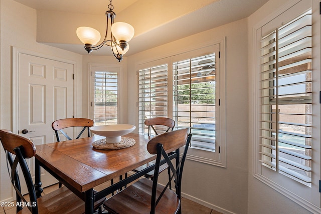 1125 S Larkspur St, Gilbert, AZ 85296 - dining space with baseboards and a chandelier