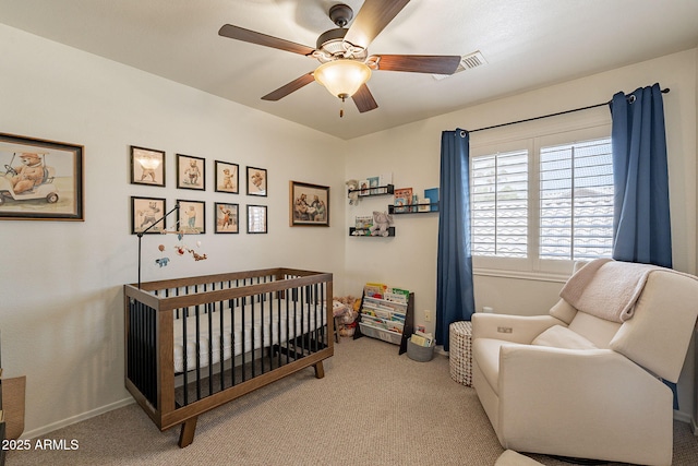 1125 S Larkspur St, Gilbert, AZ 85296 - carpeted bedroom with a nursery area, a ceiling fan, and baseboards