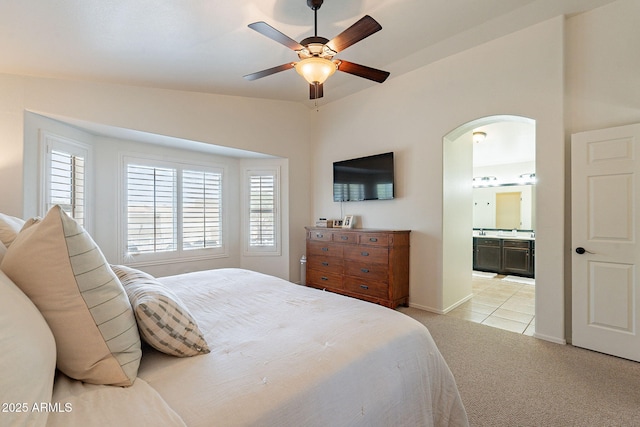 1125 S Larkspur St, Gilbert, AZ 85296 - bedroom featuring arched walkways, light colored carpet, multiple windows, and ensuite bathroom