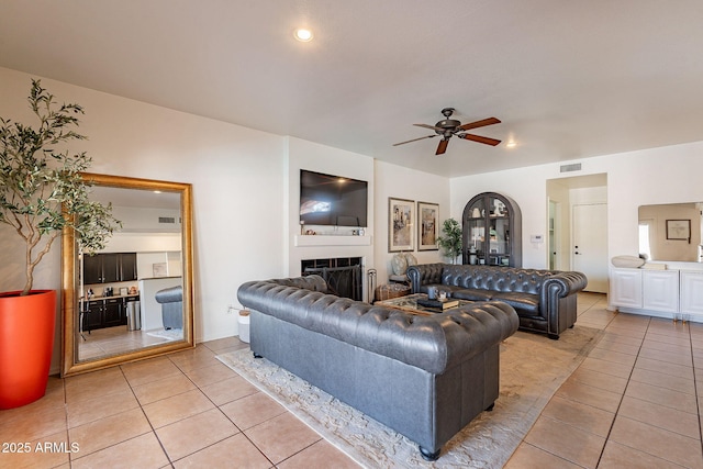 1125 S Larkspur St, Gilbert, AZ 85296 - living area with light tile patterned floors, ceiling fan, a fireplace, and recessed lighting
