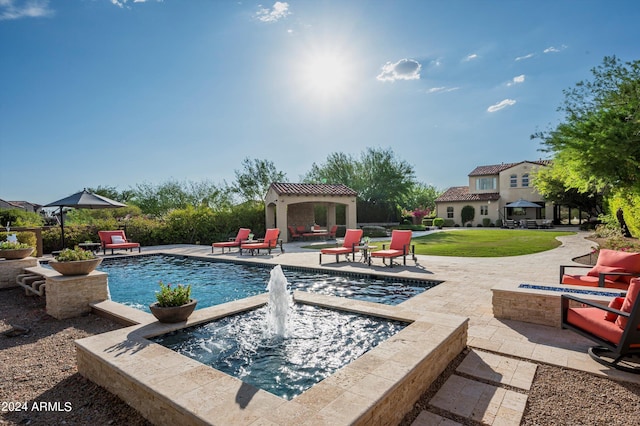 view of pool with a lawn, a gazebo, pool water feature, and a patio area