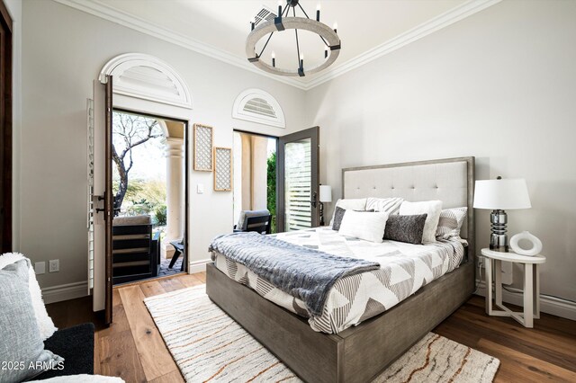 bedroom with ceiling fan, hardwood / wood-style floors, and ornamental molding