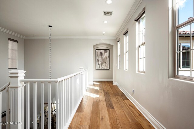 living area with light wood-type flooring, a mountain view, and ornamental molding