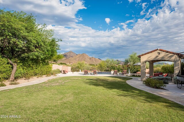 view of home's community with outdoor lounge area and a yard