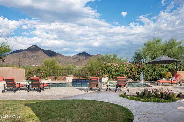 view of pool featuring pool water feature and a patio