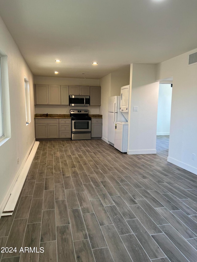 kitchen with gray cabinetry, stainless steel appliances, and dark hardwood / wood-style floors