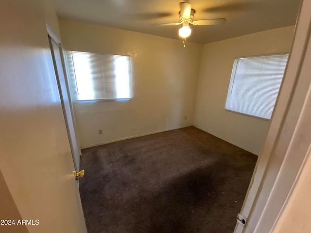 unfurnished room with ceiling fan and carpet flooring