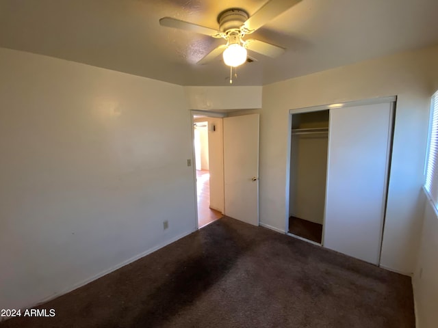 unfurnished bedroom featuring carpet flooring, ceiling fan, and a closet