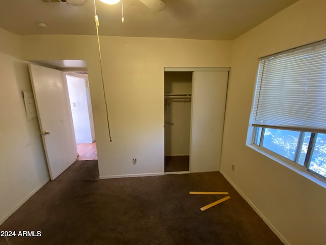 unfurnished bedroom with a closet and carpet floors