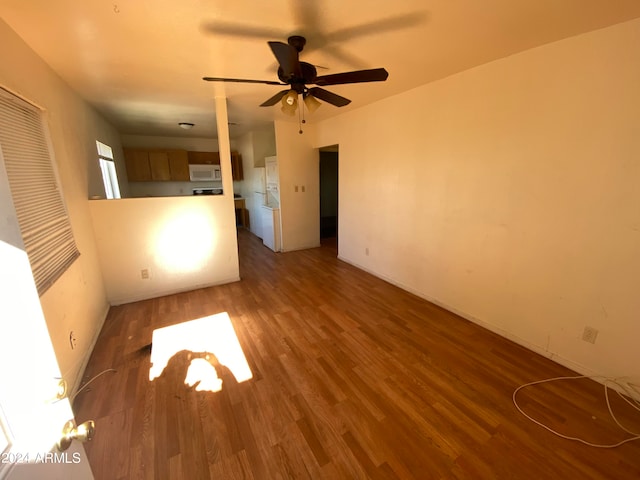 interior space featuring dark wood-type flooring and ceiling fan