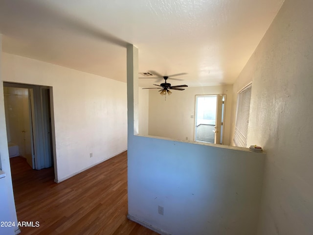 spare room featuring dark hardwood / wood-style flooring and ceiling fan