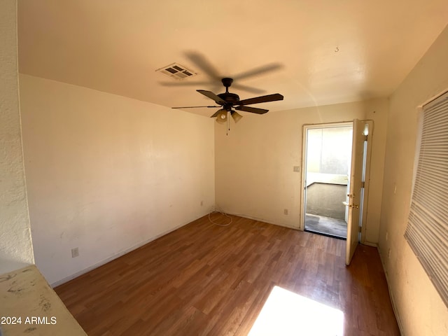 empty room featuring ceiling fan and dark hardwood / wood-style flooring