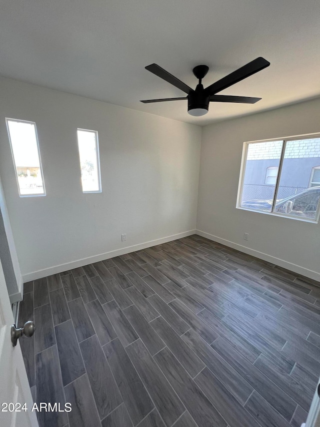 unfurnished room with ceiling fan and dark hardwood / wood-style floors