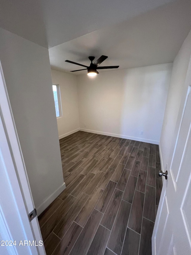 unfurnished room with dark wood-type flooring and ceiling fan