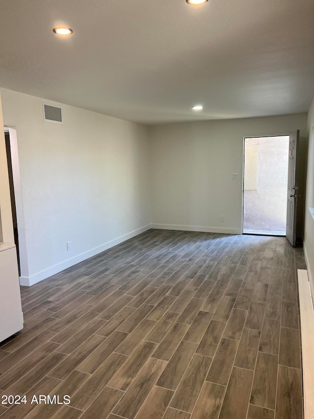 unfurnished room with dark hardwood / wood-style floors