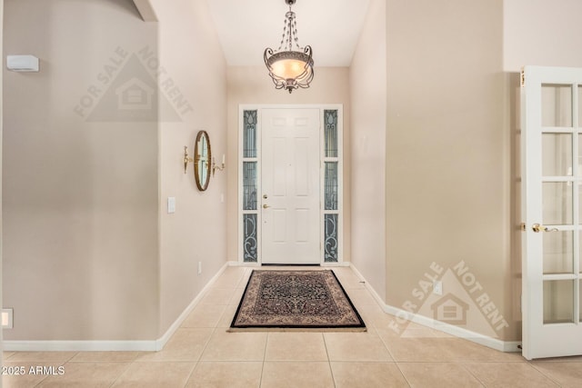 entryway featuring baseboards and tile patterned floors