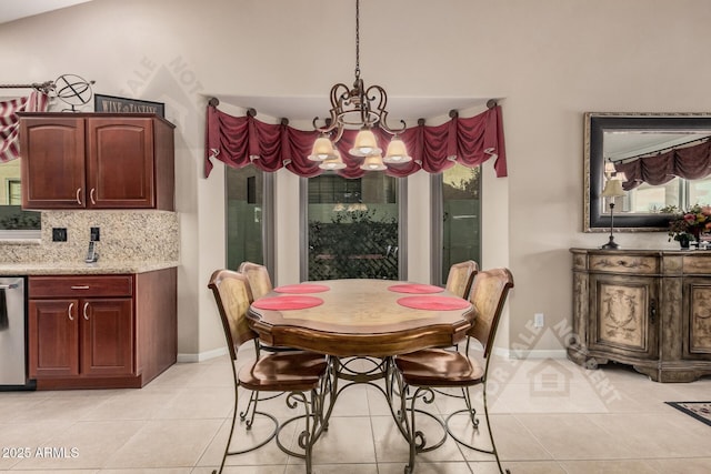 dining area featuring light tile patterned flooring, a notable chandelier, and baseboards