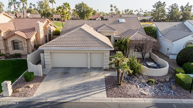 view of front of home with a garage, a residential view, a tile roof, and driveway