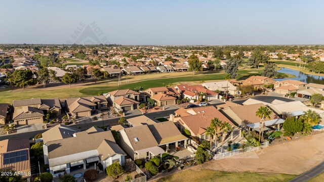 drone / aerial view with a water view, a residential view, and golf course view