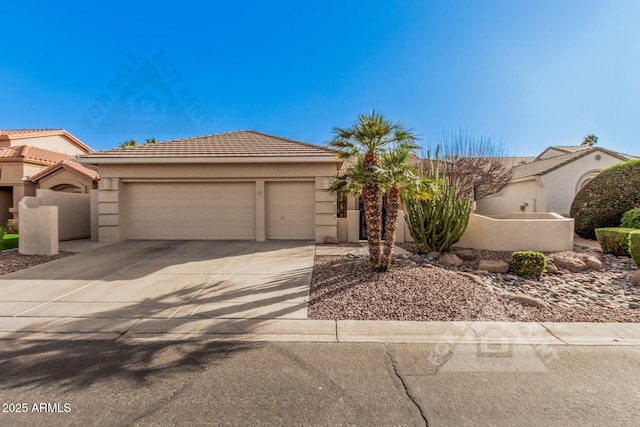 view of front facade featuring an attached garage, a tile roof, concrete driveway, and stucco siding