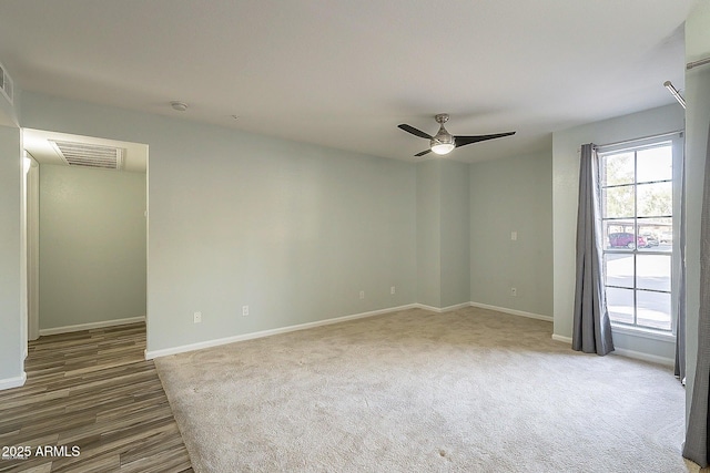 empty room featuring visible vents, carpet flooring, baseboards, and a ceiling fan