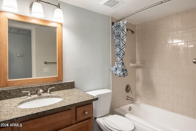 bathroom with visible vents, shower / tub combo with curtain, toilet, vanity, and a textured wall