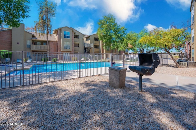 pool featuring a residential view and fence