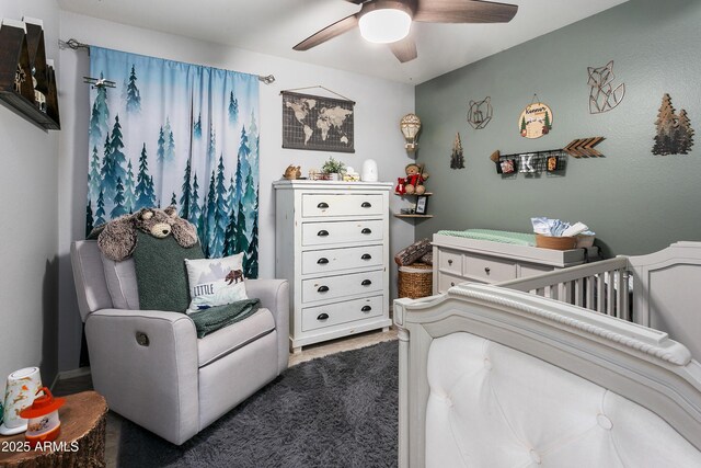 4704 E Melinda Ln, Phoenix, AZ 85050 - bedroom with a crib and a ceiling fan