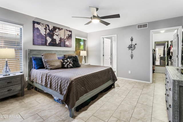 4704 E Melinda Ln, Phoenix, AZ 85050 - bedroom with a walk in closet, multiple windows, ceiling fan, and ensuite bathroom