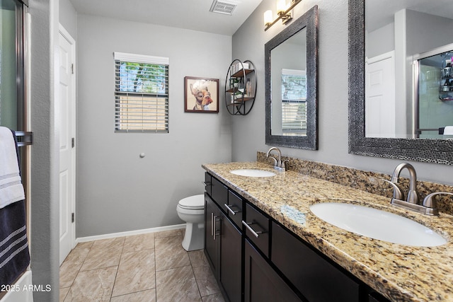 4704 E Melinda Ln, Phoenix, AZ 85050 - bathroom featuring double vanity, baseboards, toilet, and a shower with door