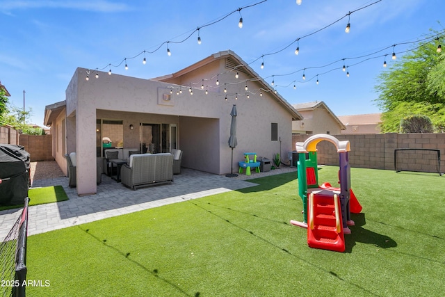 4704 E Melinda Ln, Phoenix, AZ 85050 - rear view of house with stucco siding, a patio, a playground, and outdoor lounge area
