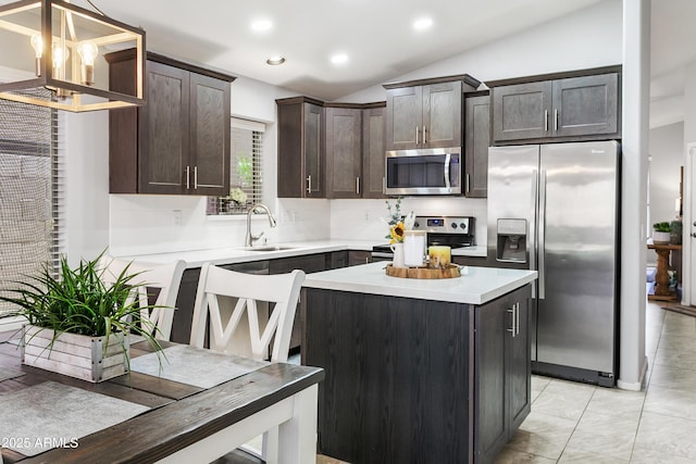 4704 E Melinda Ln, Phoenix, AZ 85050 - kitchen featuring stainless steel appliances, a sink, dark brown cabinetry, vaulted ceiling, and light countertops