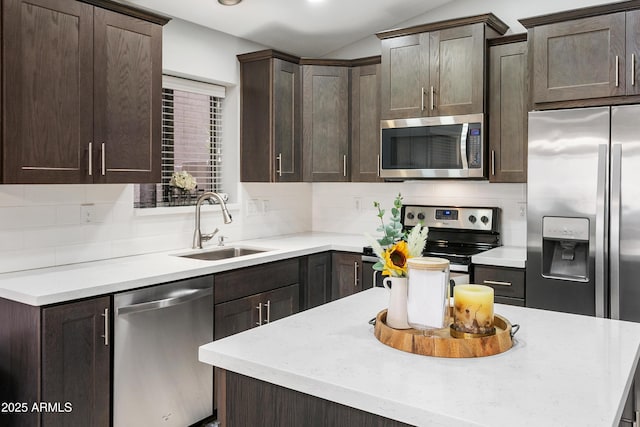 4704 E Melinda Ln, Phoenix, AZ 85050 - kitchen with appliances with stainless steel finishes, a sink, dark brown cabinetry, backsplash, and recessed lighting