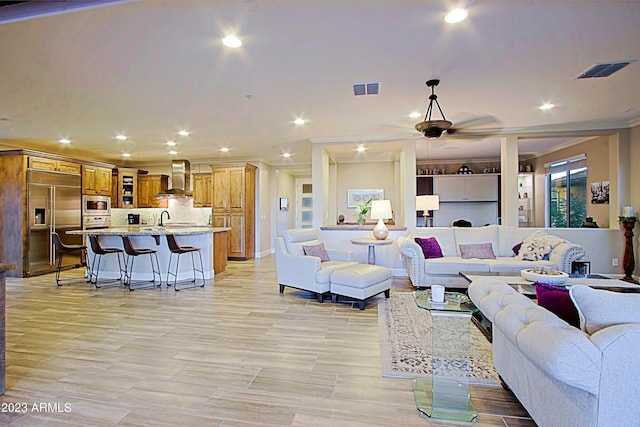 living room featuring ornamental molding, recessed lighting, visible vents, and ceiling fan