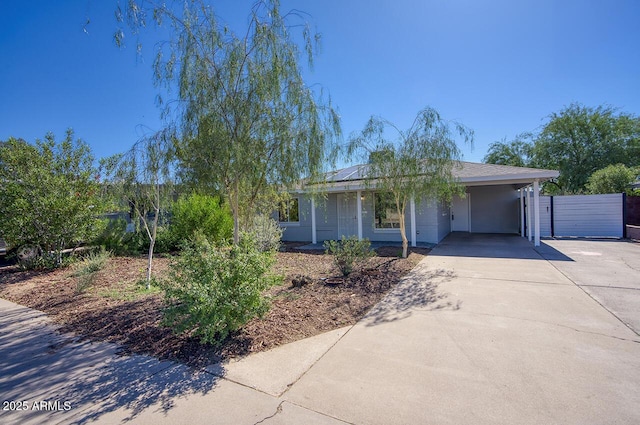 3841 N 21st Ave, Phoenix, AZ 85015 - single story home with driveway, an attached carport, solar panels, and covered porch