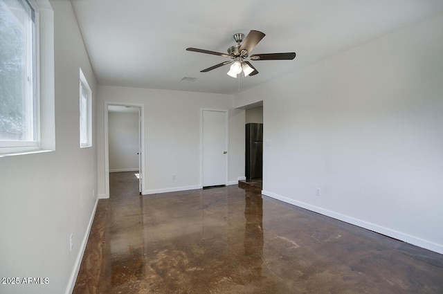 3841 N 21st Ave, Phoenix, AZ 85015 - empty room featuring finished concrete floors, baseboards, and a ceiling fan