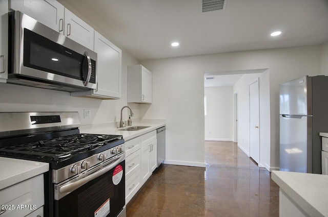 3841 N 21st Ave, Phoenix, AZ 85015 - kitchen with stainless steel appliances, a sink, baseboards, finished concrete floors, and light countertops