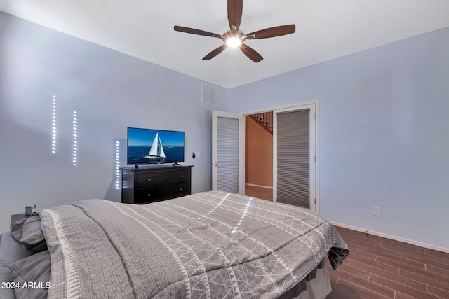 bedroom featuring dark wood-type flooring, a closet, and ceiling fan