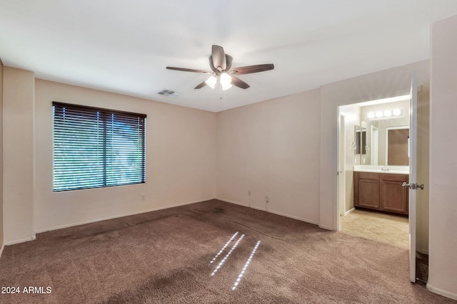 carpeted spare room with ceiling fan