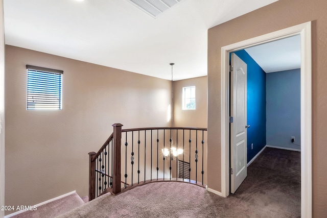 corridor with dark colored carpet