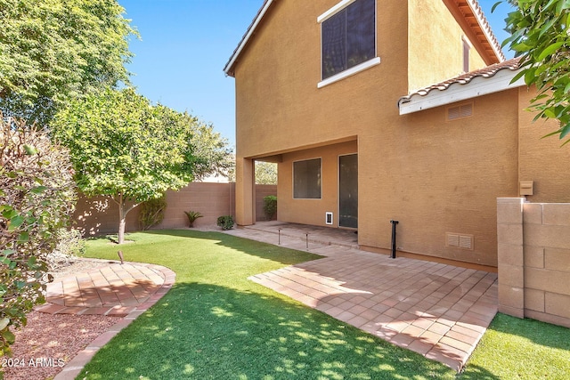 rear view of property with a patio area and a lawn